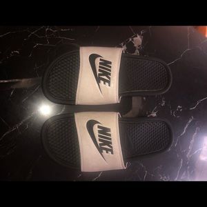 Pair of Nike white and black slides, size 9 men’s